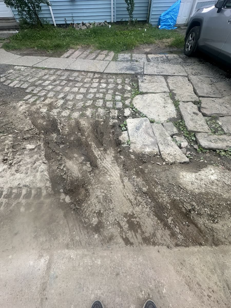 Driveway demolition — existing stone surface broken up and removed, Rochester NY