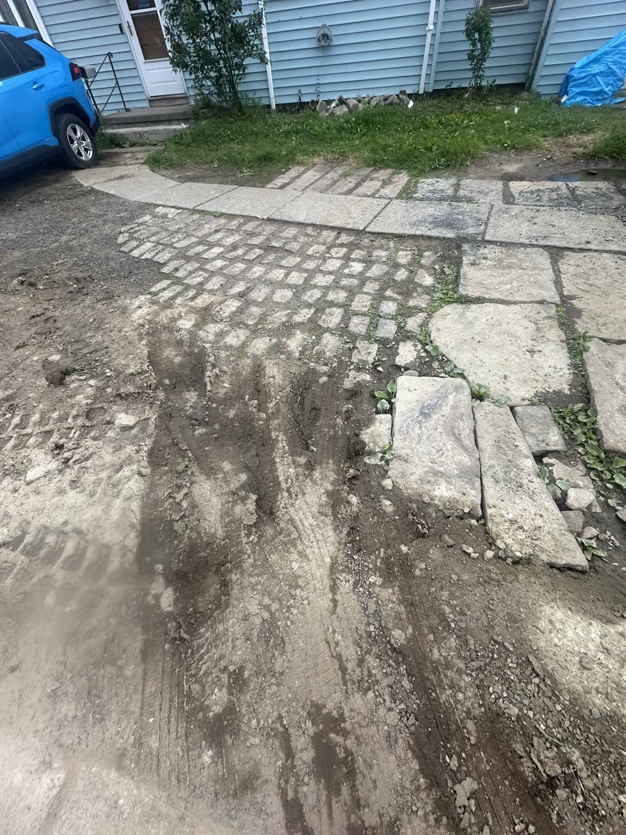 Excavation and sub-base grading in progress — concrete driveway Rochester NY