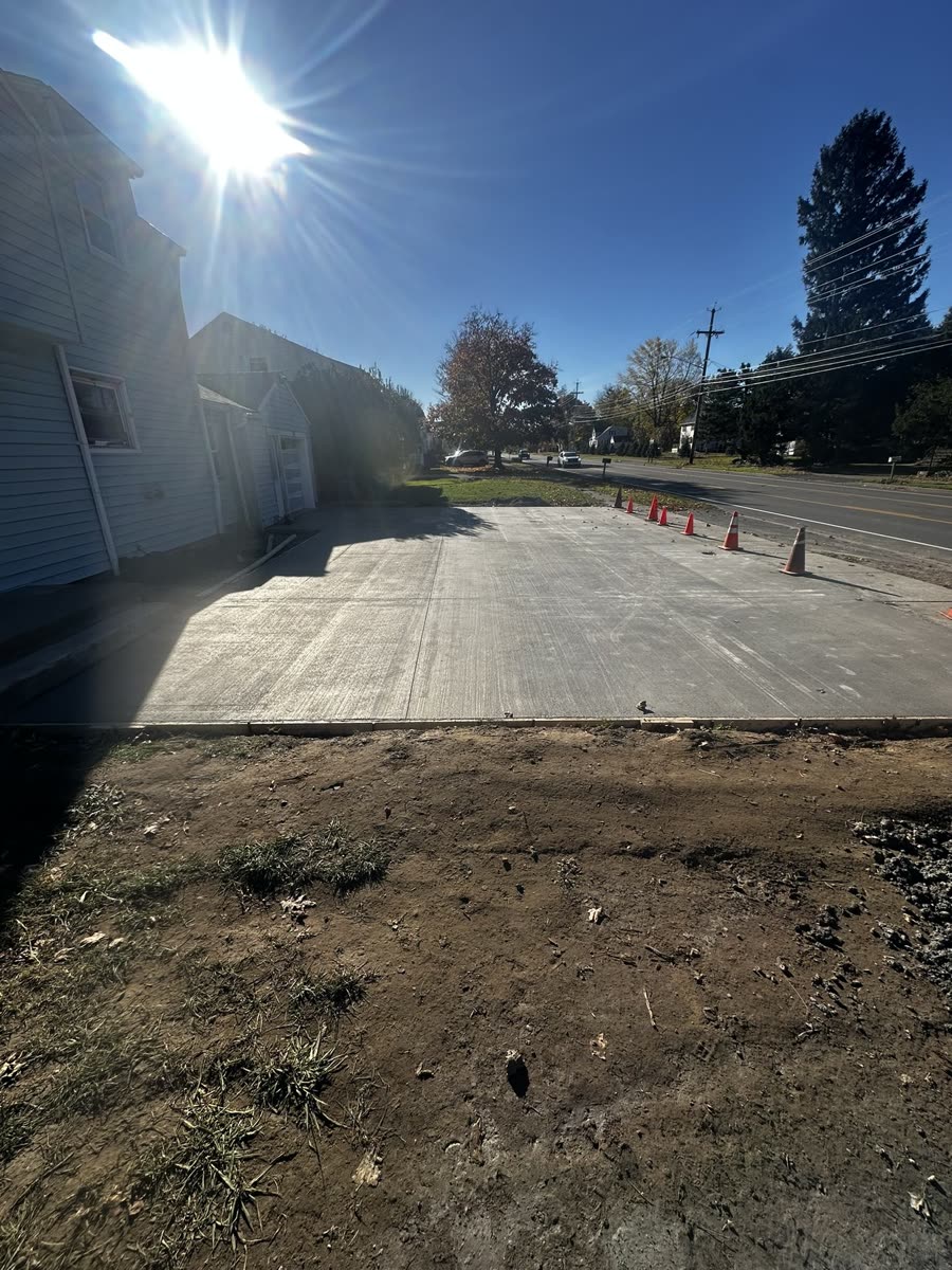 Finished concrete driveway with clean broom-finish texture — Rochester NY